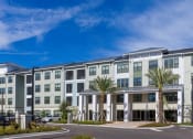 Thumbnail 53 of 60 - Longleaf Apartments building surrounded by palm trees in St. Johns, FL.