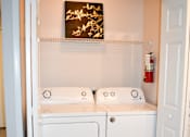 Thumbnail 11 of 28 - A white cabinet with a door open in a room.