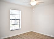 Thumbnail 28 of 28 - A room with a window and a ceiling fan.