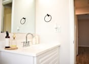Thumbnail 19 of 28 - A bathroom with a white sink and a mirror above it.