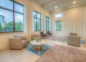 Thumbnail 9 of 40 - a living room with a couch and a table