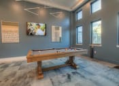 Thumbnail 13 of 40 - a pool table in a game room with windows