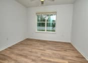 Thumbnail 18 of 40 - an empty room with a window and a ceiling fan