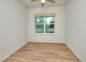 Thumbnail 19 of 40 - an empty room with a window and a ceiling fan