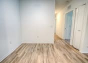 Thumbnail 34 of 40 - a empty room with a wood floor and white walls
