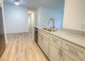 Thumbnail 20 of 40 - a kitchen with white cabinets and a sink