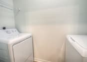 Thumbnail 21 of 40 - a white washer and dryer in a laundry room with a white dryer