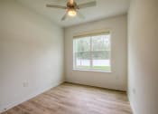 Thumbnail 23 of 40 - an empty room with a ceiling fan and a window