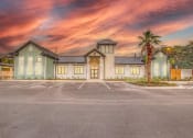 Thumbnail 8 of 40 - a building with a parking lot and a cloudy sky