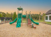 Thumbnail 2 of 40 - a playground with slides and a swing set