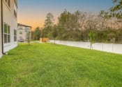 Thumbnail 3 of 40 - the backyard of a house with a yard and a fence