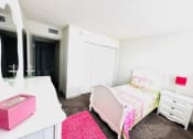 Thumbnail 21 of 46 - a bedroom with a bed and a desk and a mirror