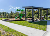 Thumbnail 20 of 23 - Lofts at San Marco East | Jacksonville, FL | Playground & Picnic Tables
