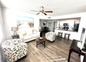 Thumbnail 14 of 46 - a living room with furniture and a ceiling fan