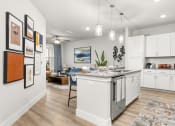 Thumbnail 2 of 60 - Spacious kitchen with high-end finishes and pendant lighting