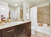 Thumbnail 9 of 114 - Luxurious, spa-inspired bathroom with elegant fixtures at Med Center in Houston, TX.