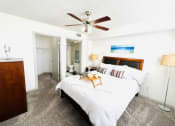 Thumbnail 16 of 46 - a bedroom with a bed and a ceiling fan
