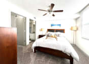 Thumbnail 17 of 46 - a bedroom with a bed and a ceiling fan