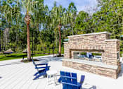 Thumbnail 48 of 60 - Cozy outdoor fireplace at Longleaf at St. Johns, St. Johns, FL, perfect for gatherings