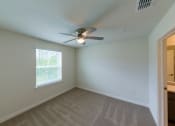 Thumbnail 4 of 16 - Molly Crossing| Middleburg, FL | Bedroom with Carpeting and Ceiling Fan