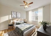 Thumbnail 11 of 13 - A bedroom with a bed, nightstand, and a ceiling fan.