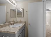 Thumbnail 9 of 10 - an empty bathroom with a sink and a mirror
