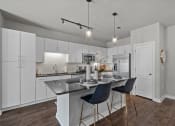 Thumbnail 2 of 22 - Designer Kitchen with Stainless Steel Appliance at Spinning Mill Lofts, Clayton, NC 27520