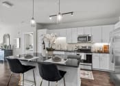 Thumbnail 1 of 22 - Designer Kitchen with Stainless Steel Appliances at Spinning Mill Lofts, Clayton, NC, 27520