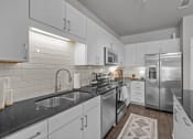 Thumbnail 3 of 22 - Designer Kitchen with Stainless Steel Appliances at Spinning Mill Lofts, Clayton, 27520