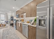Thumbnail 3 of 63 - A modern kitchen with a refrigerator on the right side.at Adler Montford Park + Drexel Townes, Charlotte, NC, 28209