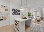 Thumbnail 6 of 63 - A white kitchen island with a wooden top and shelves below it.at Adler Montford Park + Drexel Townes, Charlotte, NC, 28209
