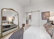 Thumbnail 8 of 63 - A bedroom with a large bed and a large mirror.at Adler Montford Park + Drexel Townes, Charlotte, NC, 28209