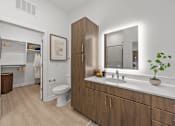 Thumbnail 9 of 63 - A bathroom with a toilet, sink, and mirror.at Adler Montford Park + Drexel Townes, Charlotte, NC, 28209