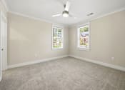 Thumbnail 36 of 63 - A room with a ceiling fan and two windows.
