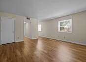 Thumbnail 1 of 10 - the living room and dining room of an empty house with wood flooring