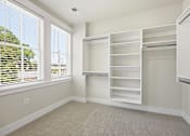 Thumbnail 30 of 63 - A room with a large window and a built-in shelving unit.