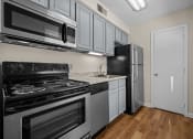 Thumbnail 5 of 10 - a kitchen with stainless steel appliances and white cabinets