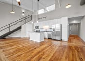 Thumbnail 16 of 22 - an open kitchen with stainless steel appliances and white cabinets at Spinning Mill Lofts, Clayton, NC 27520