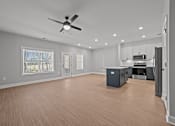 Thumbnail 17 of 30 - A spacious room with a ceiling fan and wooden flooring.at Regency Townes, North Carolina 