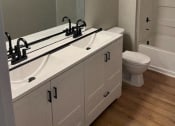 Thumbnail 5 of 13 - Renovated Bathroom at Granville Oaks Apartment Homes, Creedmoor, NC 27522