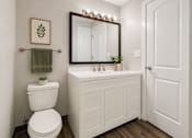 Thumbnail 2 of 13 - A white toilet sits next to a white sink in a bathroom.