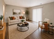 Thumbnail 5 of 13 - A living room with a white couch, a coffee table, and a chair.