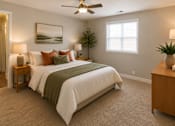 Thumbnail 4 of 13 - A bedroom with a bed, a ceiling fan, and a painting on the wall.