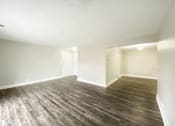 Thumbnail 12 of 13 - A room with wooden flooring and white walls.