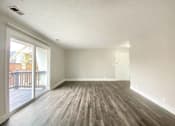Thumbnail 13 of 13 - A room with a wooden floor and white walls.