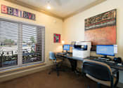 Thumbnail 11 of 14 - a home office with two computers and a printer on a desk