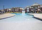 Thumbnail 13 of 13 - A large swimming pool with a fountain in the middle of it.