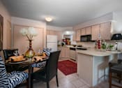 Thumbnail 18 of 27 - A kitchen with a dining table set for two.