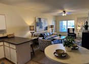 Thumbnail 4 of 21 - A living room with a black countertop and a grey sofa.