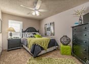 Thumbnail 4 of 11 - a bedroom with a bed and a ceiling fan